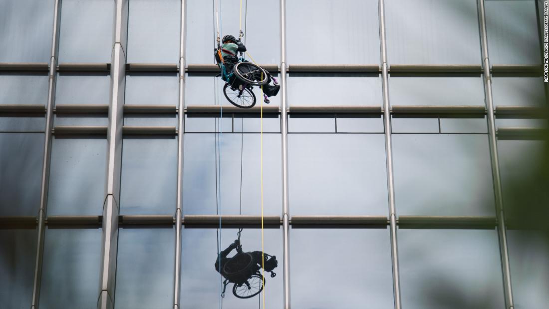 A paraplegic Hong Kong athlete in a wheelchair climbs a skyscraper